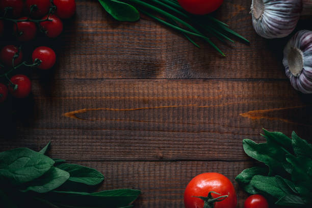 istock Flat lay of different vegetables on old dark wooden table and copy space. 1151021736