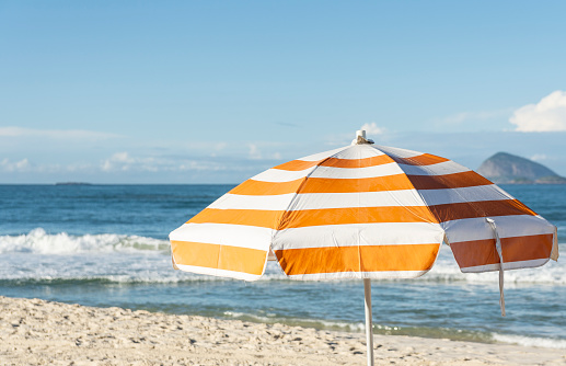 Empty beach with beach umbrella on a sunny day