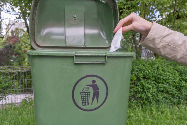 istock Woman hand throwing crumpled paper in bin 1151022934