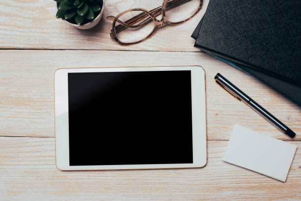 istock White digital tablet on wooden table. Flat lay. 1151024339