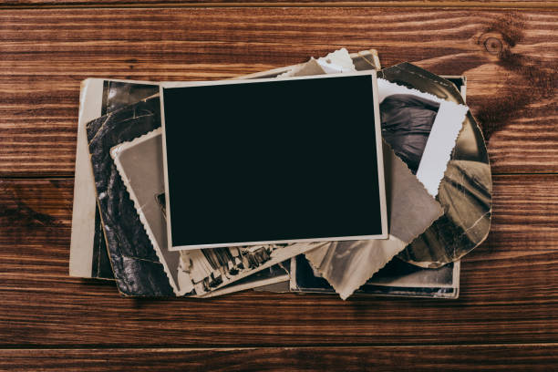 istock Stack old photos on table. Mock-up blank paper. Postcard rumpled and dirty vintage. Retro card 1151024445