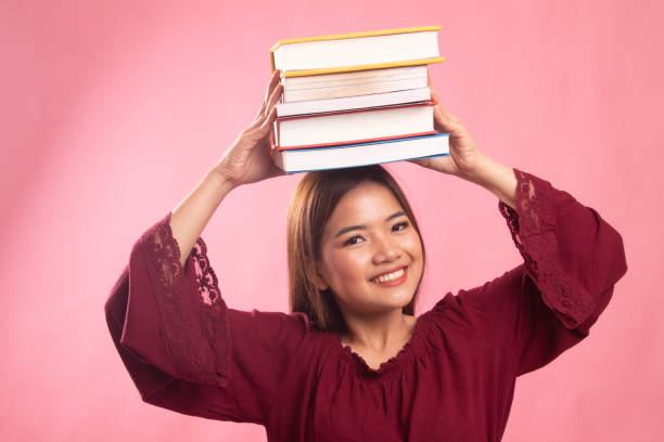 istock Young Asian woman studying  with may books. 1151024465