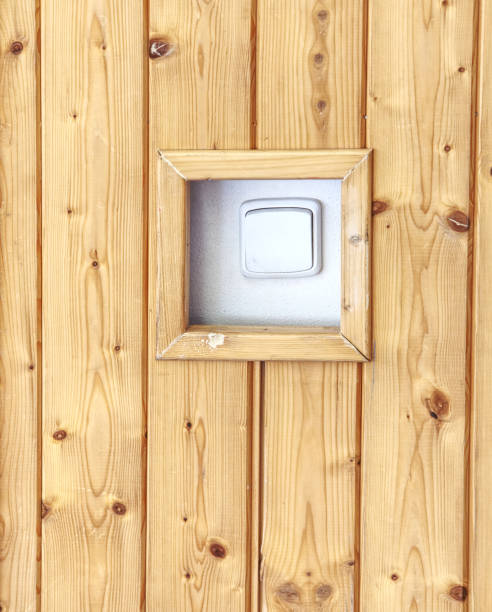 istock White switcher on wall. Wooden wall with white switch, b 1151026522