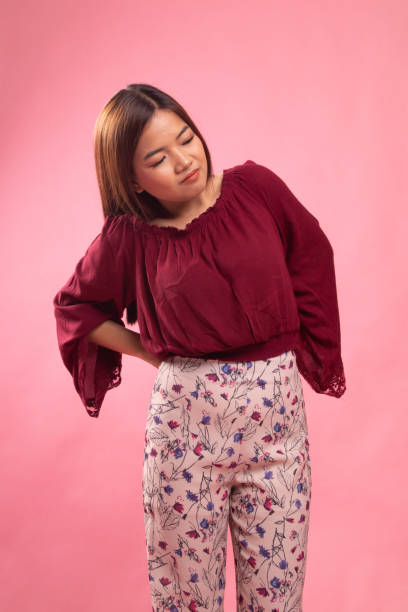 istock Young Asian woman got back pain. 1151029805