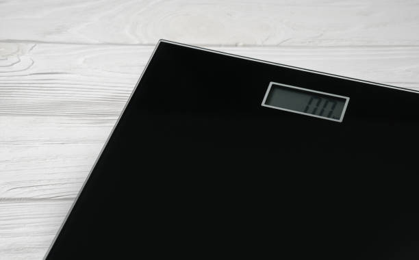 Number zero on Digital bathroom weight scale screen on white wooden background