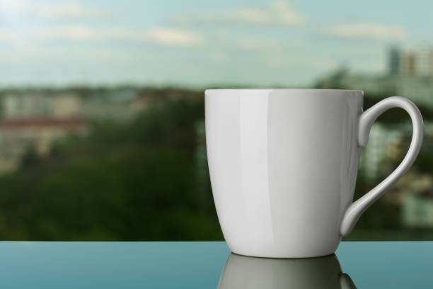Blank white mug on windowsill outdoor