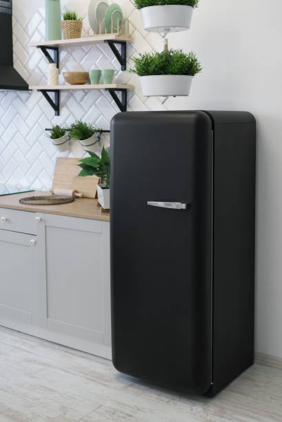 istock Black retro design fridge in white wooden kitchen 1151031450