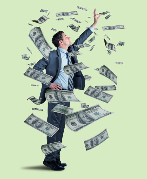 istock Businessman Reaches For Floating Money 1151031489