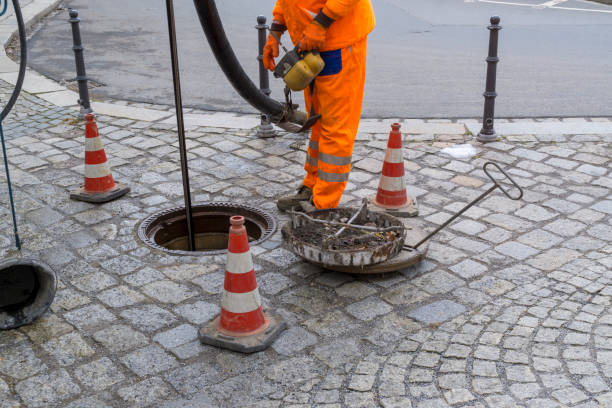 istock sewerage worker on street cleaning pipe 1151031667