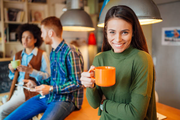 istock A woman smiling and working with her colleagues 1151036306