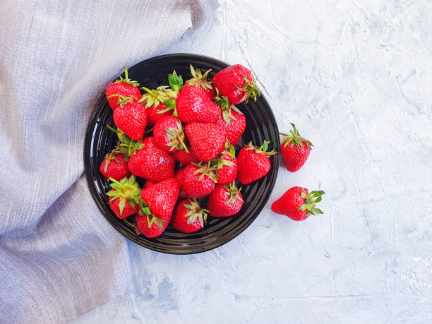 fresh strawberry plate on gray concrete background