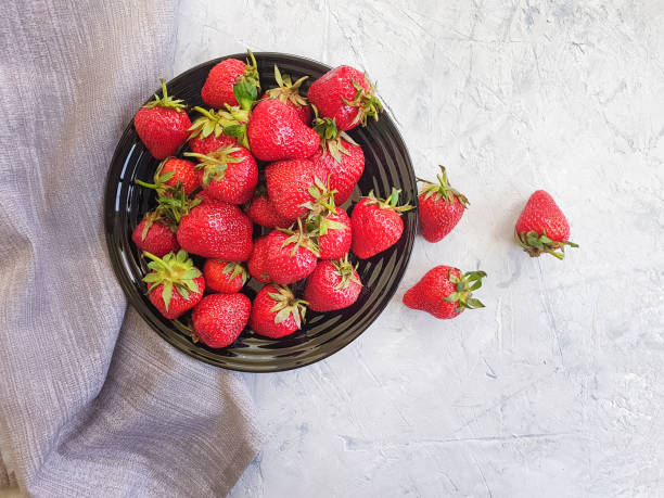 fresh strawberry plate on gray concrete background