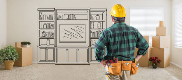 istock Contractor Inside Room With Boxes Facing Entertainment Unit Drawing On Wall 1151040879