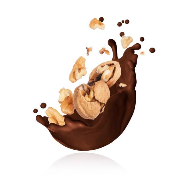 istock Splash of melted chocolate with crushed walnut closeup on white background 1151040901