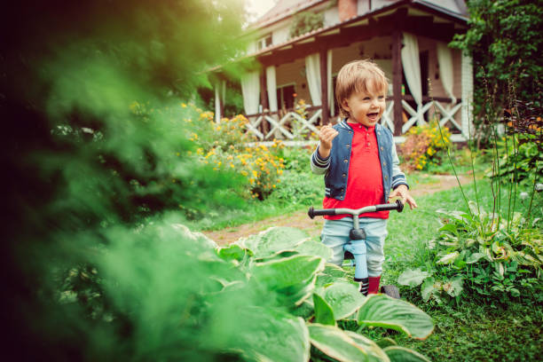 Child with bike having fun at back yard