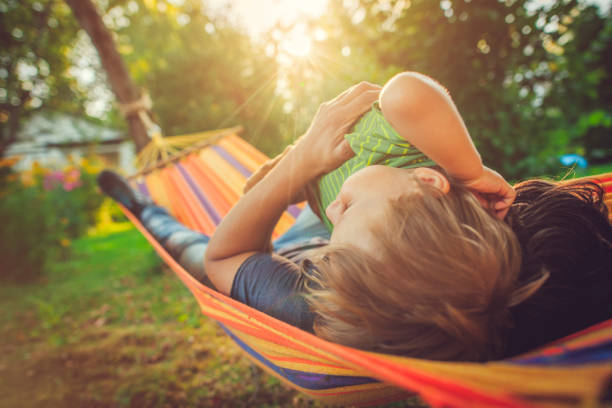 istock Family enjoying spring/summer day in hammock 1151043100
