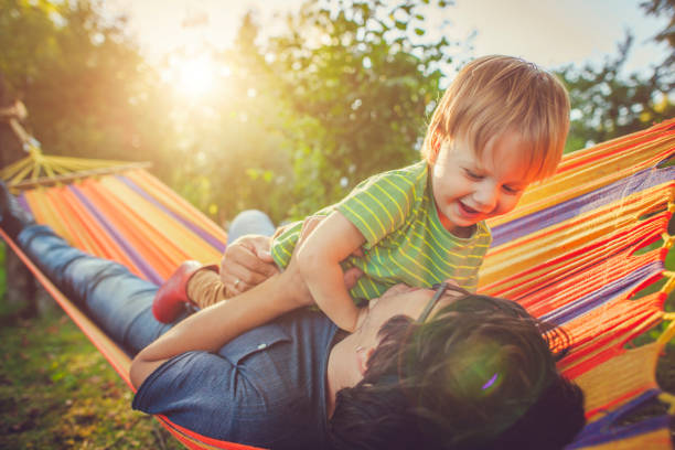 istock Family enjoying spring/summer day in hammock 1151043105