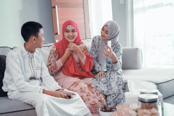 istock three friend muslim sitting on a couch and having conversation 1151044609