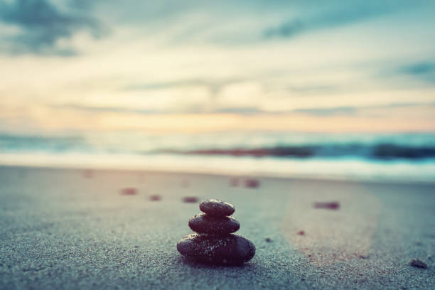 istock Stones pyramid on the beach at sunset. Zen 1151044982