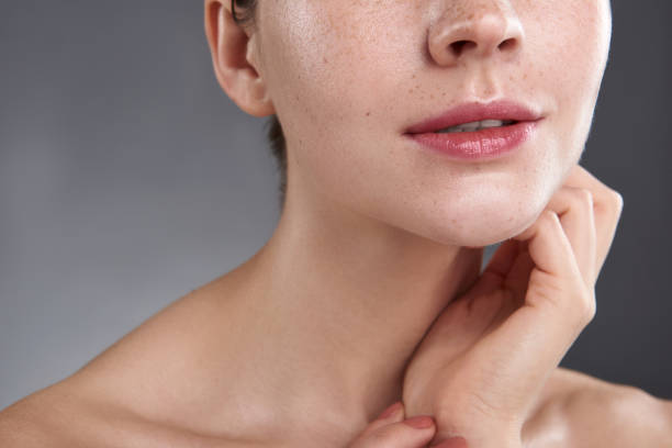 istock Young woman with beautiful rosy lips touching her neck 1151045703