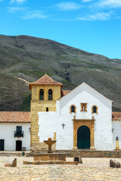 Vertical view of church and fountain in the main plaza in Villa de Leyva, Colombia