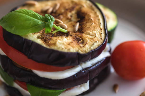 Grilled eggplant and zucchini slices with fresh tomato and mozzarella cheese, close-up