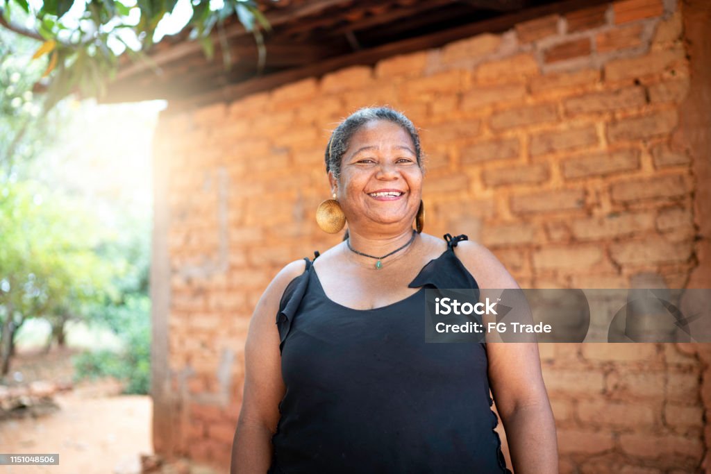 Portrait of a mature woman in front of a wattle and daub house Brazil Stock Photo