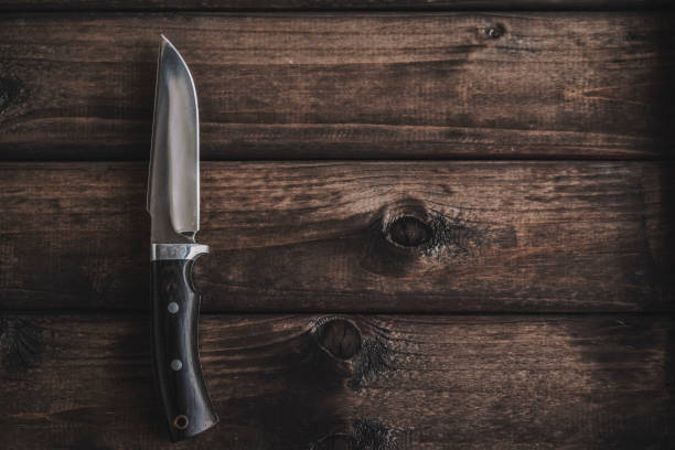 istock knife on wooden background 1151049043