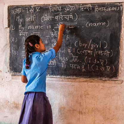 Indian schoolgirl in classroom, English language class, Rajasthan, India