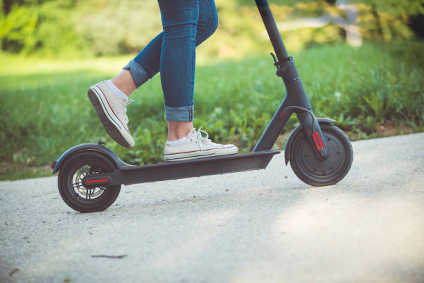 istock Woman riding motor scooter at park 1151049664