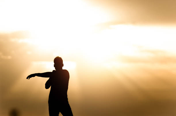 istock Silhouette of young athlete stretching during a sunset. 1151051555