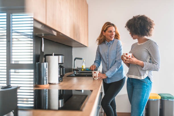 istock Young woman talking with friend in the kitchen 1151053671