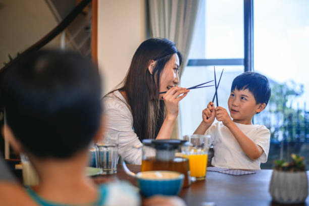 istock Taiwanese Mother and Son Playing With Chopsticks 1151053854