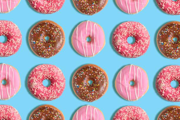 istock Colorful donut pattern on pastel blue background. Creative minimal summer concept. 1151055591