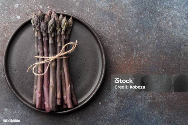 Bunch Of Purple Asparagus On Rusty Background Stock Photo - Download Image Now - Asparagus, Black Color, Bunch