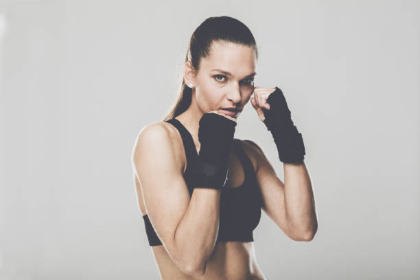 istock Sporting woman in boxing bandages looking at camera 1151057886