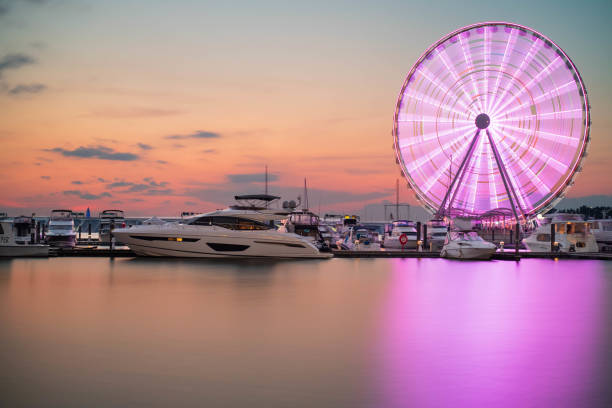 Ferris Wheel at National Harbor, Maryland Ferris wheel seen at sunset time at the National Harbor in Oxon Hill, Maryland harbor stock pictures, royalty-free photos & images