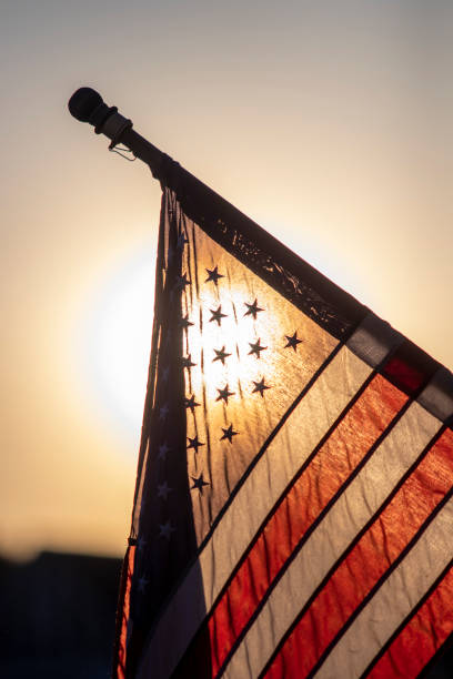 istock American flag backlit at dusk 1151058660