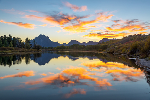 Beautiful colorful sunset reflected in the Snake River in Grand Teton National Park