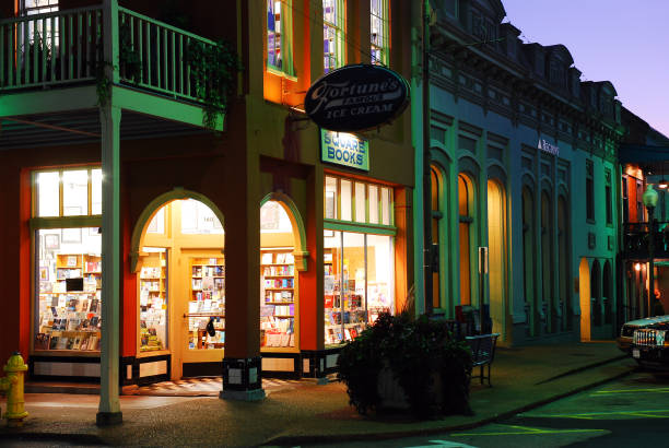 Square Books, downtown Oxford Mississippi Oxford, MS,USA July 21, 2010 The soft light of Square Books, in downtown Oxford, Mississippi, filters onto the street at dusk oxford mississippi photos stock pictures, royalty-free photos & images