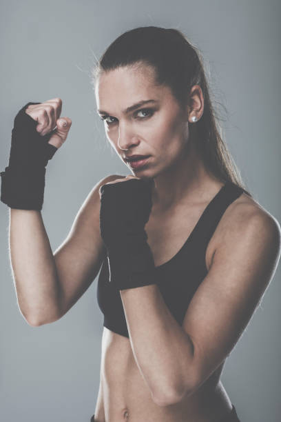 istock Sporting woman in boxing bandages looking at camera 1151064153