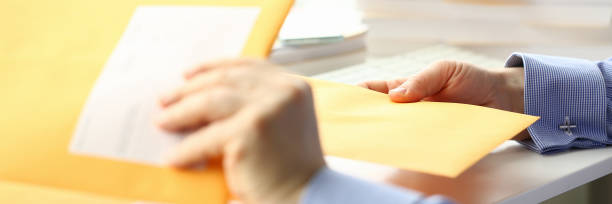 istock Businessman hold hand yellow mail envelope 1151066698
