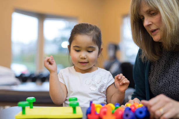 istock Occupational therapist works with a young ethnic girl 1151067616