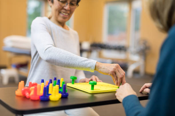 istock Occupational therapist works with an elderly woman 1151067624