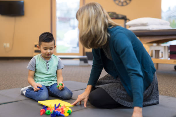 istock Occupational therapist works with a young ethnic boy 1151075146