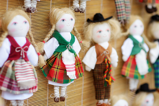 Cute handmade ragdoll dolls in Lithuanian national costumes sold on Easter market in Vilnius. Lithuanian capital's annual traditional crafts fair is held every March on Old Town streets.