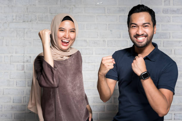 Malaysian couple celebrating for good news.
