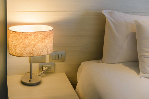 istock Turn on bedside lamp on bedside table in the bedroom 1151087055