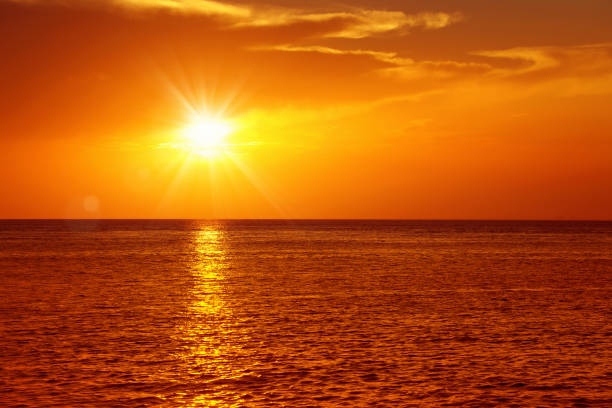istock seascape with shiny sea over cloudy sky and sun during sunset 1151088908