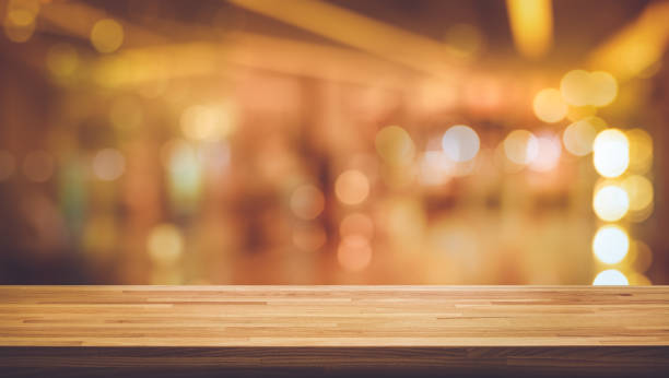 istock Wood texture table top (counter bar) with blur light gold bokeh in night cafe background 1151089962